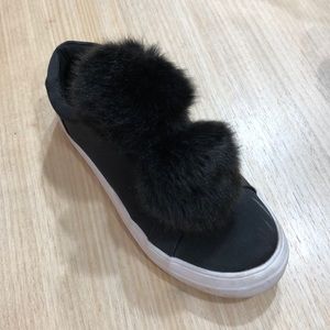 Black leather shoes with two pom poms